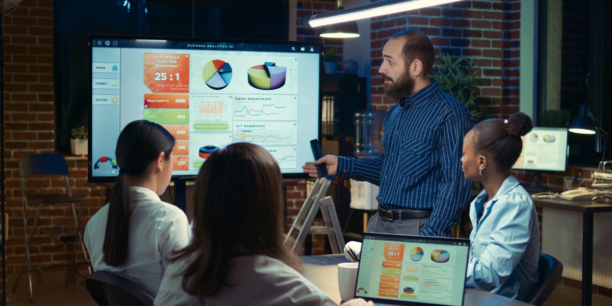 A business person presenting data and graphs to three colleagues