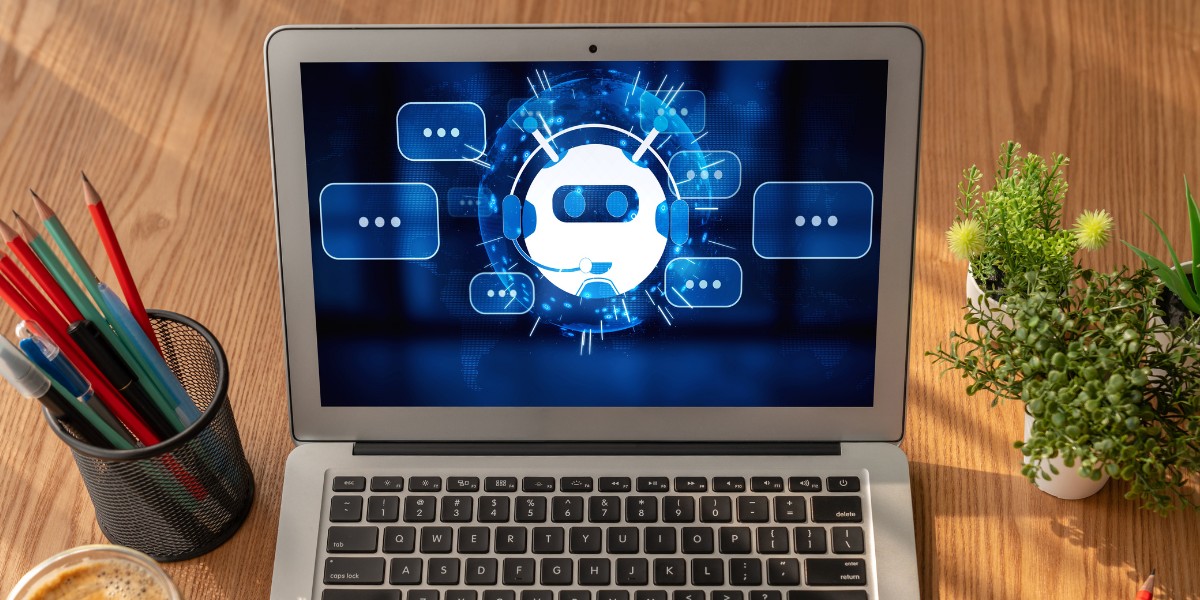 Open laptop on a desk with a visual representation of AI assistant on the screen