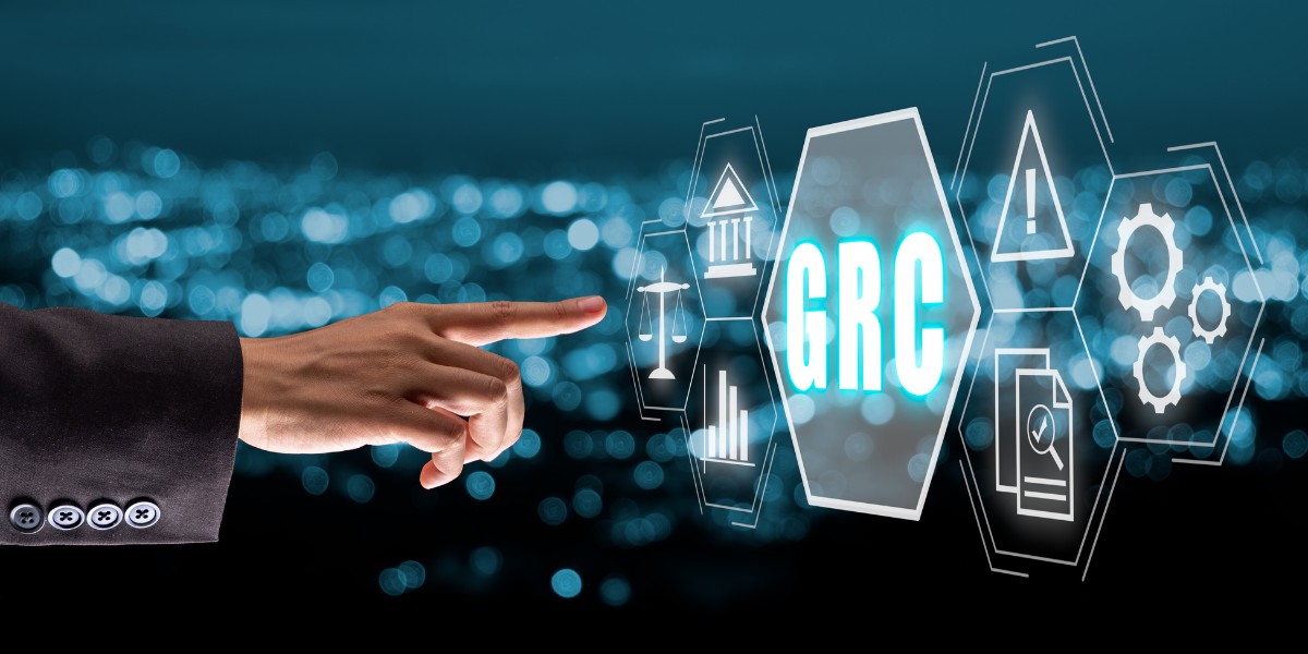 An arm reaching toward a floating digital screen displaying the letters GRC in the center with icons surrounding it representing various aspects of governance, risk, and compliance