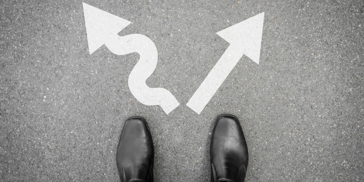 A pair of feet in business shoes standing in front of two arrows pointing in opposite directions - one is a squiggly arrow and one is stratight