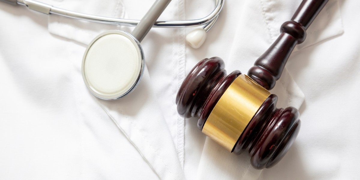A medical practitioner's white coat, a stethoscope, and a gavel
