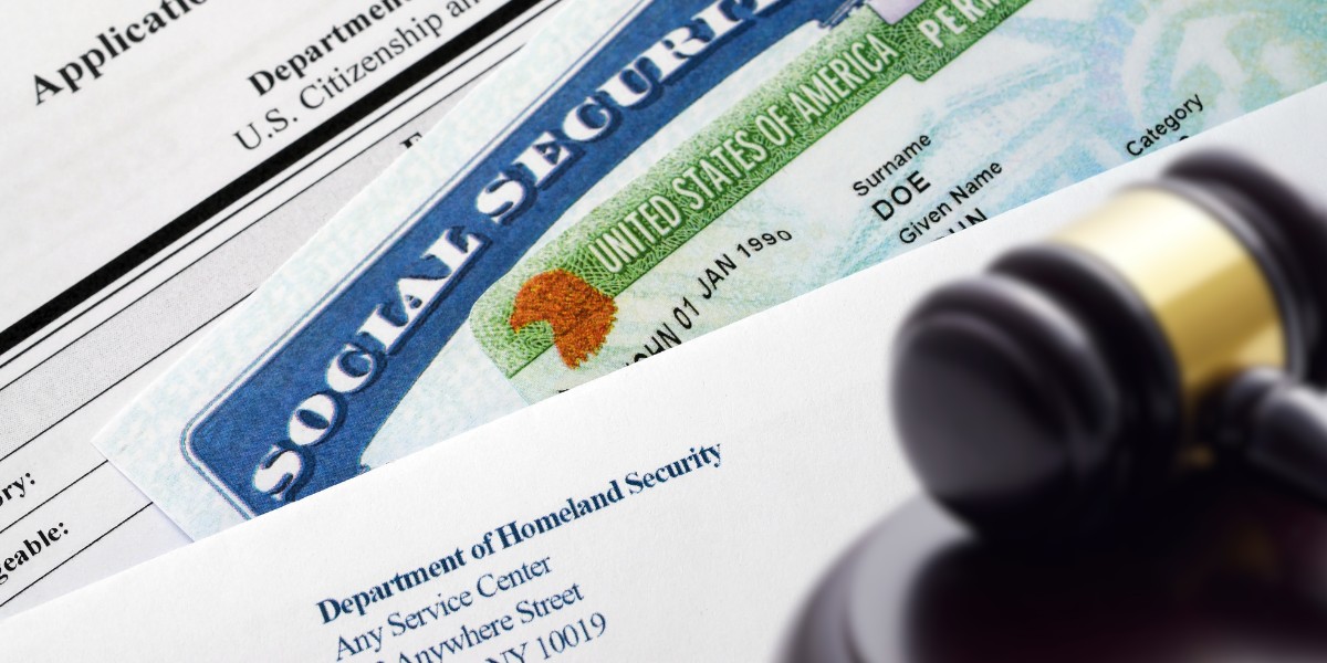 Application for immigration, social security card, residence card, and a gavel