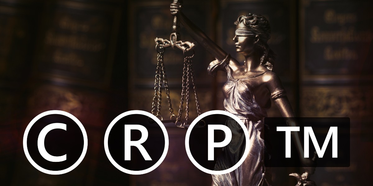 Symbols for copyright, registered trademark, patent, and trademark claim layered over a bronze statue of Lady Justice