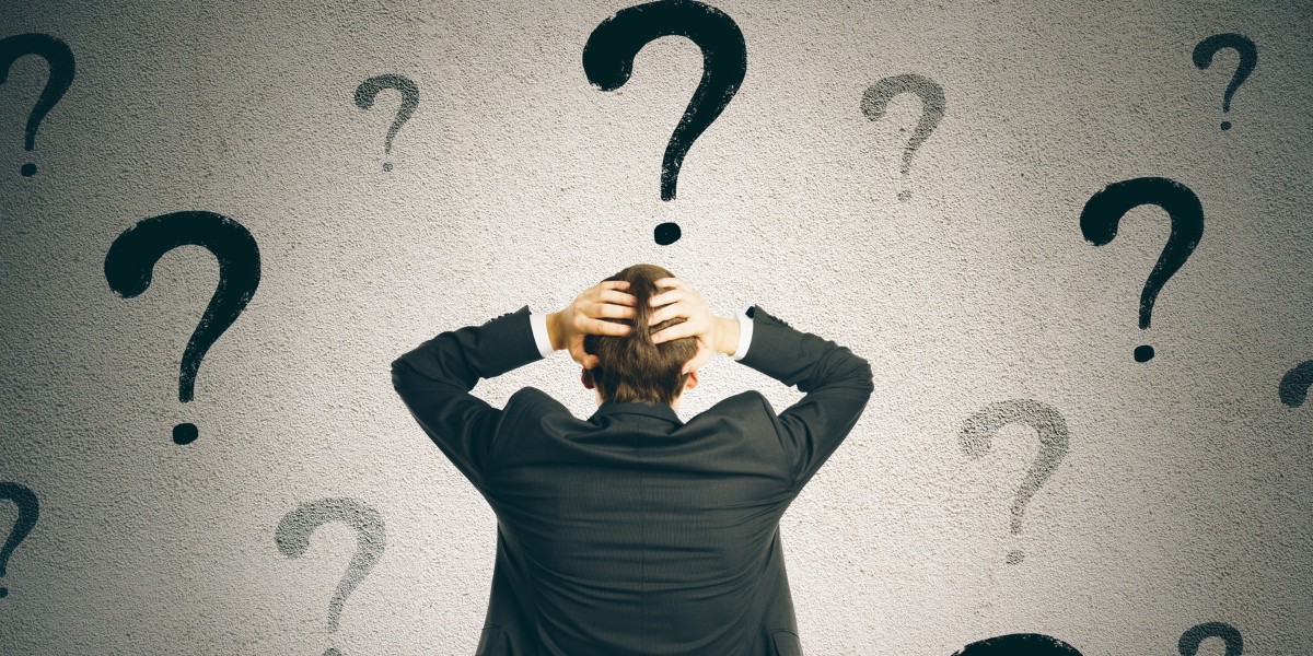 A view from behind of a person standing with their hands on their head surrounded by floating question marks